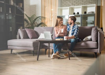 depositphotos_185638618-stock-photo-young-couple-sitting-couch-cups